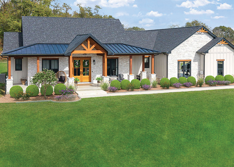Single-story modern farmhouse by a custom home builder Pittsburgh, featuring a black metal roof, stone and white siding exterior, wooden beams, covered porch, and landscaped front yard.